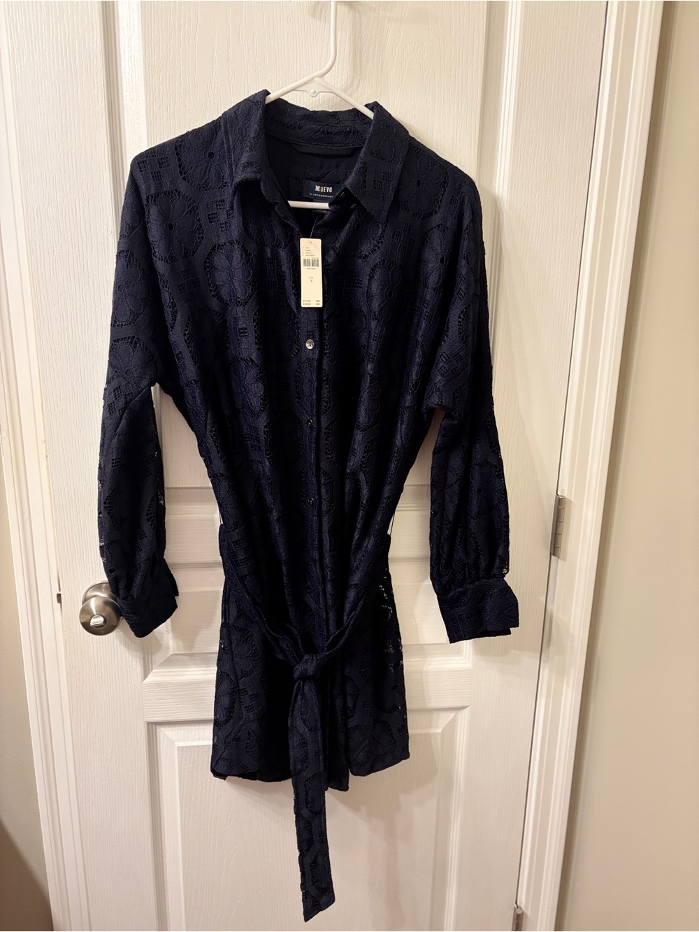 Anthropologie Maeve lace navy dress . Dress has pockets and a tie belt .